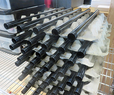 A rack of tubes for the 23-inch scopes ready to receive their options.